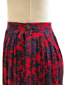 Feminine vintage red pleated skirt with a blue and purple paisley design. Midi length with side zipper closure. Beautiful vintage ribbon on inside hem finishing. A lovely piece for in-between seasons.