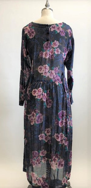 Gorgeous, airy long sleeve dress in purple and blue florals. This is made of a lightweight, sheer fabric so you will want to wear a light slip underneath. It features a v-shaped waistline with gathered skirt, and side seam pockets. The waist can be adjusted with waist ties at back. Button opening at back of bodice with a slight boat neck style. 