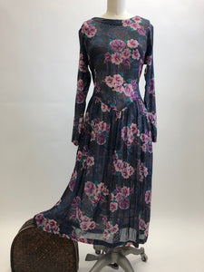 Gorgeous, airy long sleeve dress in purple and blue florals. This is made of a lightweight, sheer fabric so you will want to wear a light slip underneath. It features a v-shaped waistline with gathered skirt, and side seam pockets. The waist can be adjusted with waist ties at back. Button opening at back of bodice with a slight boat neck style. 