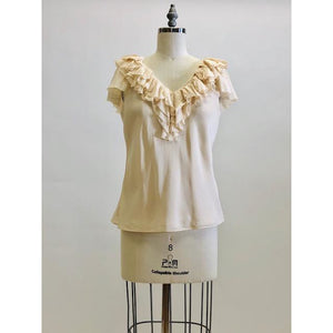 Romantic cream silk top with ruffled neckline and delicate silk flared sleeves; lined with a chiffon-like fabric. 