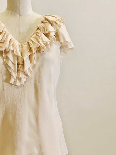 Romantic cream silk top with ruffled neckline and delicate silk flared sleeves; lined with a chiffon-like fabric. 