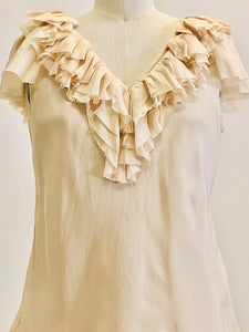 Romantic cream silk top with ruffled neckline and delicate silk flared sleeves; lined with a chiffon-like fabric. 