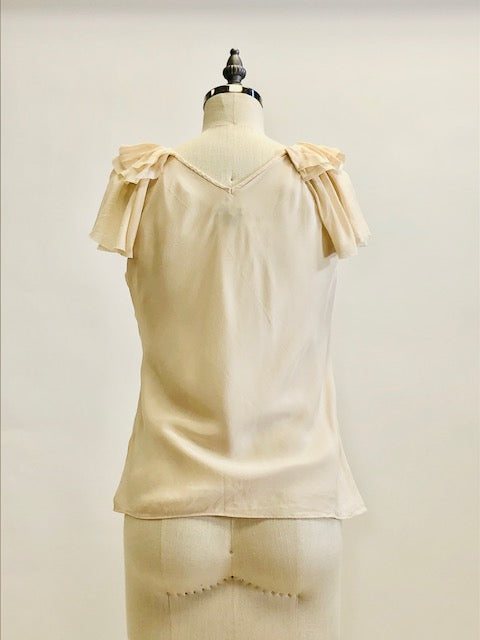 Romantic cream silk top with ruffled neckline and delicate silk flared sleeves; lined with a chiffon-like fabric. 