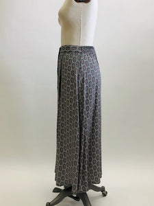 Vintage A-line maxi skirt with buttons down center front and elasticated back waistband in a soft viscose fabric in a white, black and gray regal-style print. Beautifully lightweight for in-between seasons and pairs nicely with t-shirts, sweaters and cardigans. Vintage Timothy Eaton Co. Ltd. label. 