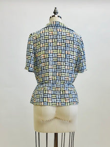 Vintage 80s style double breasted top with elasticated peplum waist, combination roll & pointed collar in a green, blue, orange rectangle pattern, accented with cute vintage silver buttons. Relaxed blousy fit looks chic with your favorite pair of vintage jeans. 