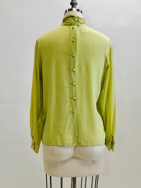 Exquisite lime silk blouse with lightly gathered neck band collar detail, button-down back, and long sleeves with buttoned cuffs. Looks beautiful paired with casual bottoms or as a dressy look.