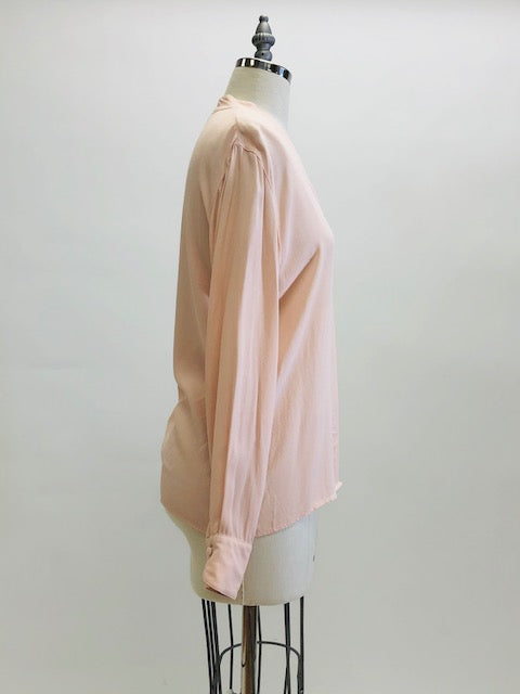 Romantic soft blush pink long-sleeve rayon blouse with v-neck line and hidden button-down front placket. Pairs beautifully with vintage denim or linen pants or skirt, or with dress pants for the office. 