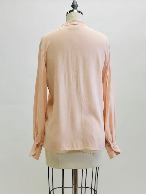 Romantic soft blush pink long-sleeve rayon blouse with v-neck line and hidden button-down front placket. Pairs beautifully with vintage denim or linen pants or skirt, or with dress pants for the office. 