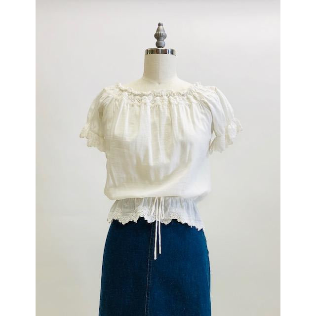 Adorable soft off-white top in a cotton/silk blend with elasticated peplum waist and neckline. This top features feminine eyelet detailing along the neckline, sleeve and waist hem, and pairs nicely with high waisted trousers, or a romantic linen skirt.