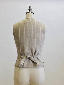 Oatmeal and white pinstripe lined vest with front flap pockets. Back waist ties for a fitted waist look. 