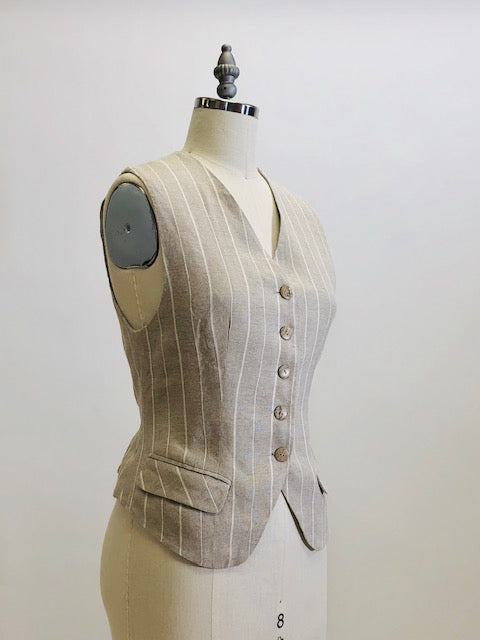 Oatmeal and white pinstripe lined vest with front flap pockets. Back waist ties for a fitted waist look. 