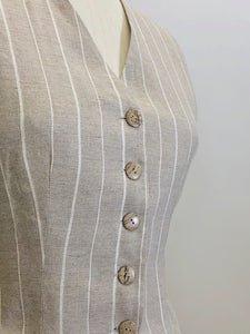 Oatmeal and white pinstripe lined vest with front flap pockets. Back waist ties for a fitted waist look. 