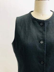 Classic black Irish linen box-style vest top with front welt pockets.  Collarless high rounded neckline. 