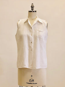 100% white Irish linen, sleeveless top with button down at center front with shell buttons, cute patch pocket with ribbon finishing and bow. Relaxed fit.