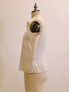 100% white Irish linen, sleeveless top with button down at center front with shell buttons, cute patch pocket with ribbon finishing and bow. Relaxed fit.