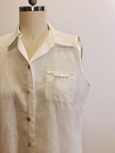 100% white Irish linen, sleeveless top with button down at center front with shell buttons, cute patch pocket with ribbon finishing and bow. Relaxed fit.