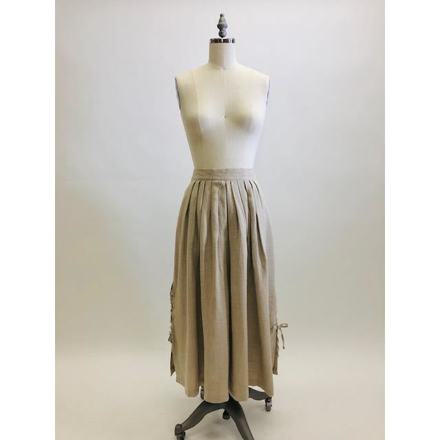 Feminine vintage full ankle skirt in ecru linen with pleats at waistband on both front and back. Center back zipper closure and side seam pockets! The cutest detailed slits with ties at sides. This is a unique find, perfect for romantic strolls, and so hard to see her go. 