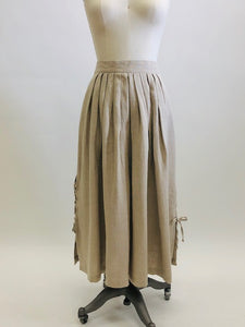 Feminine vintage full ankle skirt in ecru linen with pleats at waistband on both front and back. Center back zipper closure and side seam pockets! The cutest detailed slits with ties at sides. This is a unique find, perfect for romantic strolls, and so hard to see her go. 