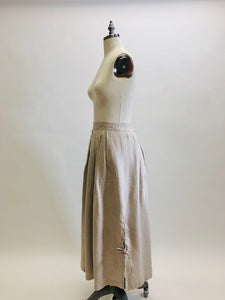 Feminine vintage full ankle skirt in ecru linen with pleats at waistband on both front and back. Center back zipper closure and side seam pockets! The cutest detailed slits with ties at sides. This is a unique find, perfect for romantic strolls, and so hard to see her go. 