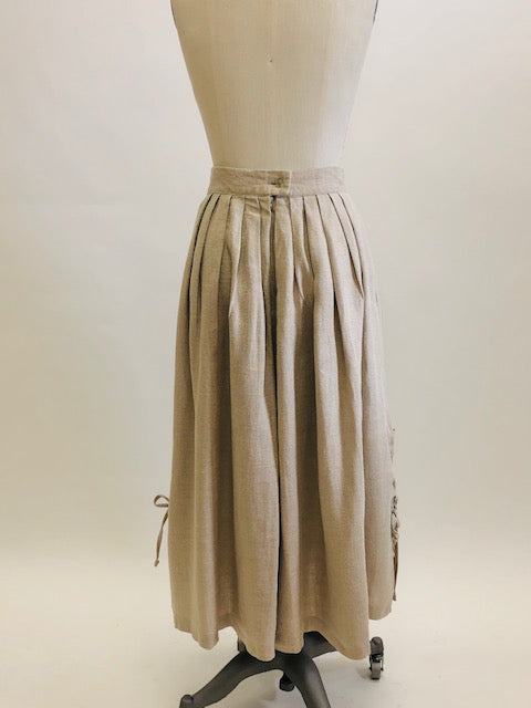 Feminine vintage full ankle skirt in ecru linen with pleats at waistband on both front and back. Center back zipper closure and side seam pockets! The cutest detailed slits with ties at sides. This is a unique find, perfect for romantic strolls, and so hard to see her go. 