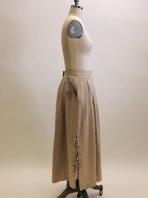 Feminine vintage full ankle skirt in ecru linen with pleats at waistband on both front and back. Center back zipper closure and side seam pockets! The cutest detailed slits with ties at sides. This is a unique find, perfect for romantic strolls, and so hard to see her go. 