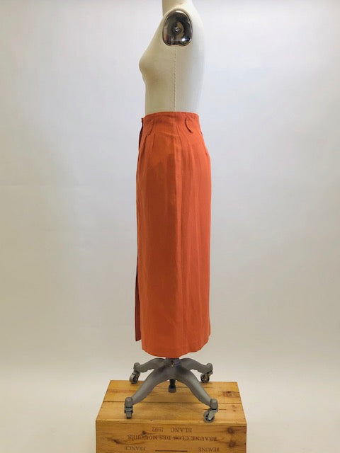 Bright terracotta midi skirt with feminine front slit and front zipper closer. Belt loops and cute back pocket with a nice casual linen/rayon texture. Super cute when worn with flat sandals. 