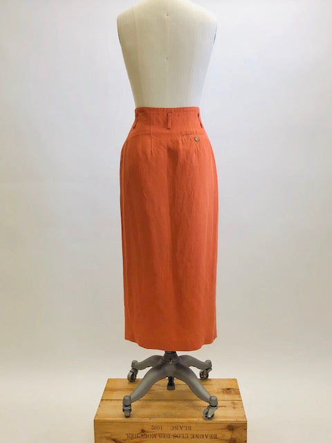 Bright terracotta midi skirt with feminine front slit and front zipper closer. Belt loops and cute back pocket with a nice casual linen/rayon texture. Super cute when worn with flat sandals. 