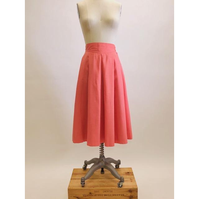 Vintage coral pink lined circle skirt with pleats at waist, yoke waistband, side seam lap zipper.  Sweet vintage skirt with ribbon hem finishing - perfect for twirling. 