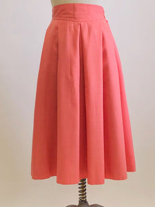 Vintage coral pink lined circle skirt with pleats at waist, yoke waistband, side seam lap zipper.  Sweet vintage skirt with ribbon hem finishing - perfect for twirling. 