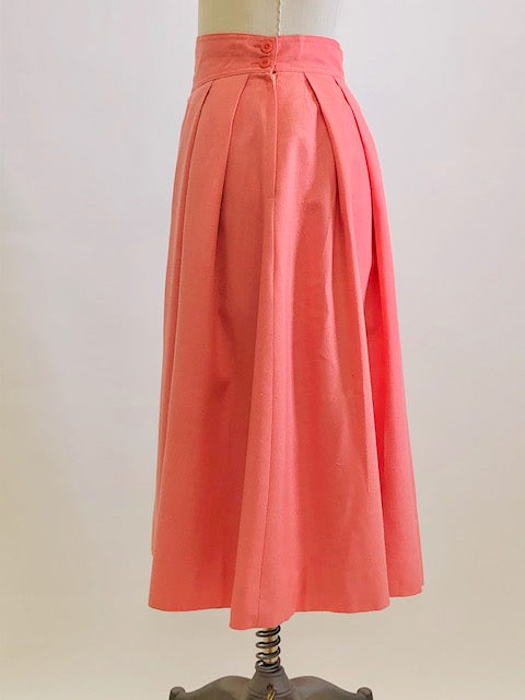 Vintage coral pink lined circle skirt with pleats at waist, yoke waistband, side seam lap zipper.  Sweet vintage skirt with ribbon hem finishing - perfect for twirling. 