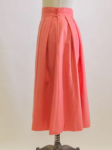 Vintage coral pink lined circle skirt with pleats at waist, yoke waistband, side seam lap zipper.  Sweet vintage skirt with ribbon hem finishing - perfect for twirling. 