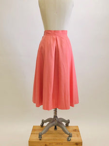 Vintage coral pink lined circle skirt with pleats at waist, yoke waistband, side seam lap zipper.  Sweet vintage skirt with ribbon hem finishing - perfect for twirling. 