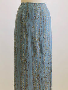 Romantic powder blue maxi skirt with delicate field vines. Lined skirt with front slit, side waist ties and back zipper closure.  