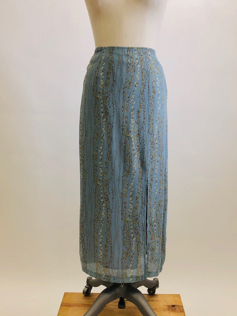 Romantic powder blue maxi skirt with delicate field vines. Lined skirt with front slit, side waist ties and back zipper closure.  