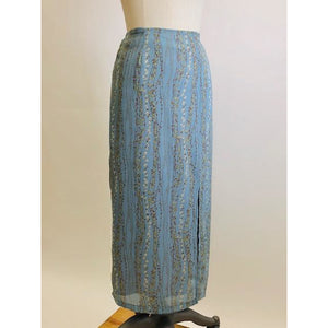 Romantic powder blue maxi skirt with delicate field vines. Lined skirt with front slit, side waist ties and back zipper closure.  