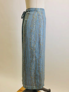 Romantic powder blue maxi skirt with delicate field vines. Lined skirt with front slit, side waist ties and back zipper closure.  