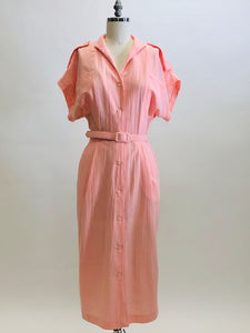 Vintage pink button down long dress with kimono sleeves with an 80s style loose fit on top and side seam pockets. Interesting asymmetrical design-shaped bust pockets. Comes with matching belt. Fabric is unknown, has a textured feel, could be a viscose/cotton blend. 