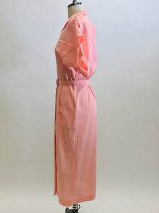 Vintage pink button down long dress with kimono sleeves with an 80s style loose fit on top and side seam pockets. Interesting asymmetrical design-shaped bust pockets. Comes with matching belt. Fabric is unknown, has a textured feel, could be a viscose/cotton blend. 