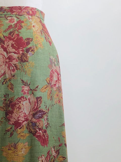 Truly beautiful & feminine midi length green skirt with rose garden print, lined with side zipper. Lightweight wool blend with a slightly A-line silhouette. As a transitional season piece, pairs nicely with your favorite pair of ankle boots. 