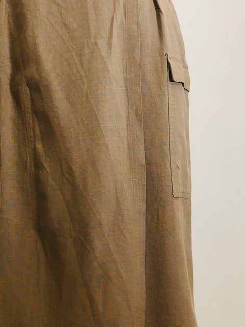 Knee length linen/viscose skirt in a dark khaki and olive tone with interesting snap front wrap overlap at waist, pin tucks at waistband and cargo pockets. Uniquely designed skirt. 