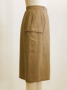 Knee length linen/viscose skirt in a dark khaki and olive tone with interesting snap front wrap overlap at waist, pin tucks at waistband and cargo pockets. Uniquely designed skirt. 