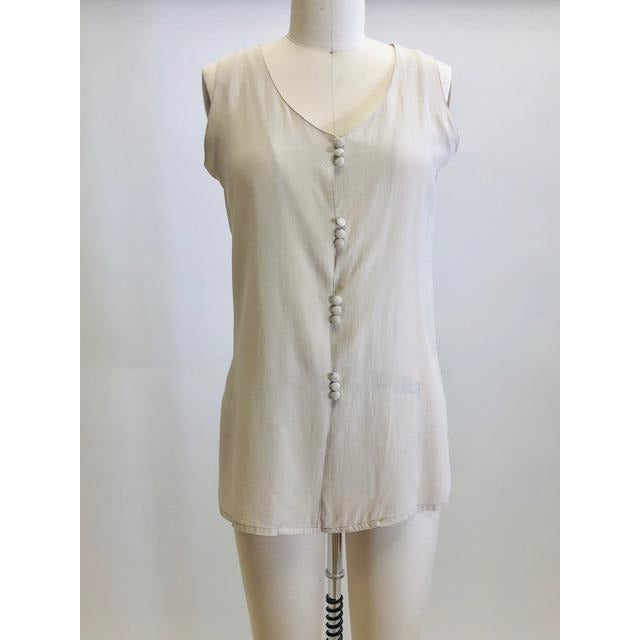 Creamy-taupe sleeveless silk top with button down front. 