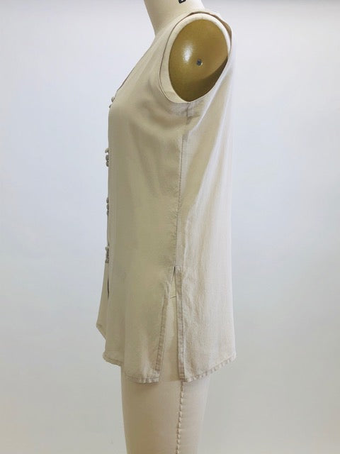 Creamy-taupe sleeveless silk top with button down front. 