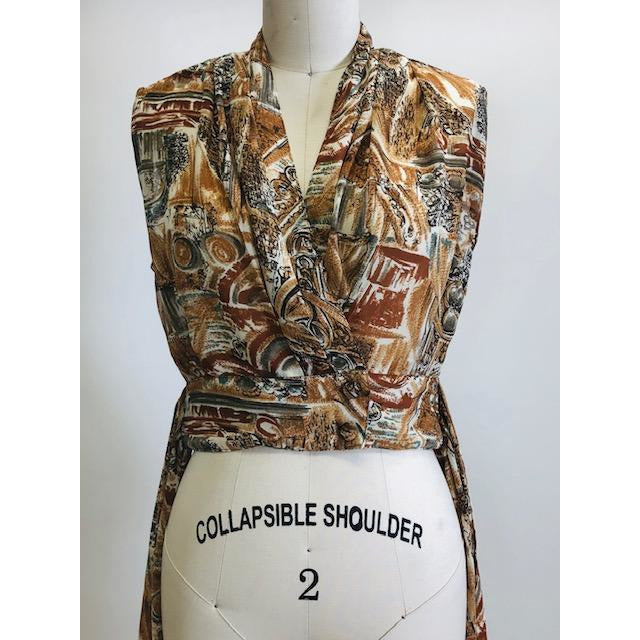 Vintage 90s short-waisted sleeveless wrap tie blouse with crossover button enclosure. Fabric pattern looks like European architectural shapes in brown tones. This top pairs nicely with high-waisted shorts or pants.