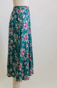 Gorgeous green-tale midi length skirt with feminine roses and elasticated waist. The label states cotton, but it's very drapey, and almost reminds me of a soft lightweight rayon in touch and drape. Has a very light lining. Perfect for twirling. 