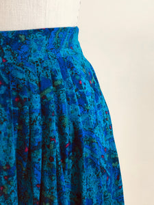 Lovely vintage 80s rayon midi pleated skirt with swirls of turquoise, green, blue and pink accents. This skirt features elasticated back waistband, and inseam side pockets. Made in Canada. 