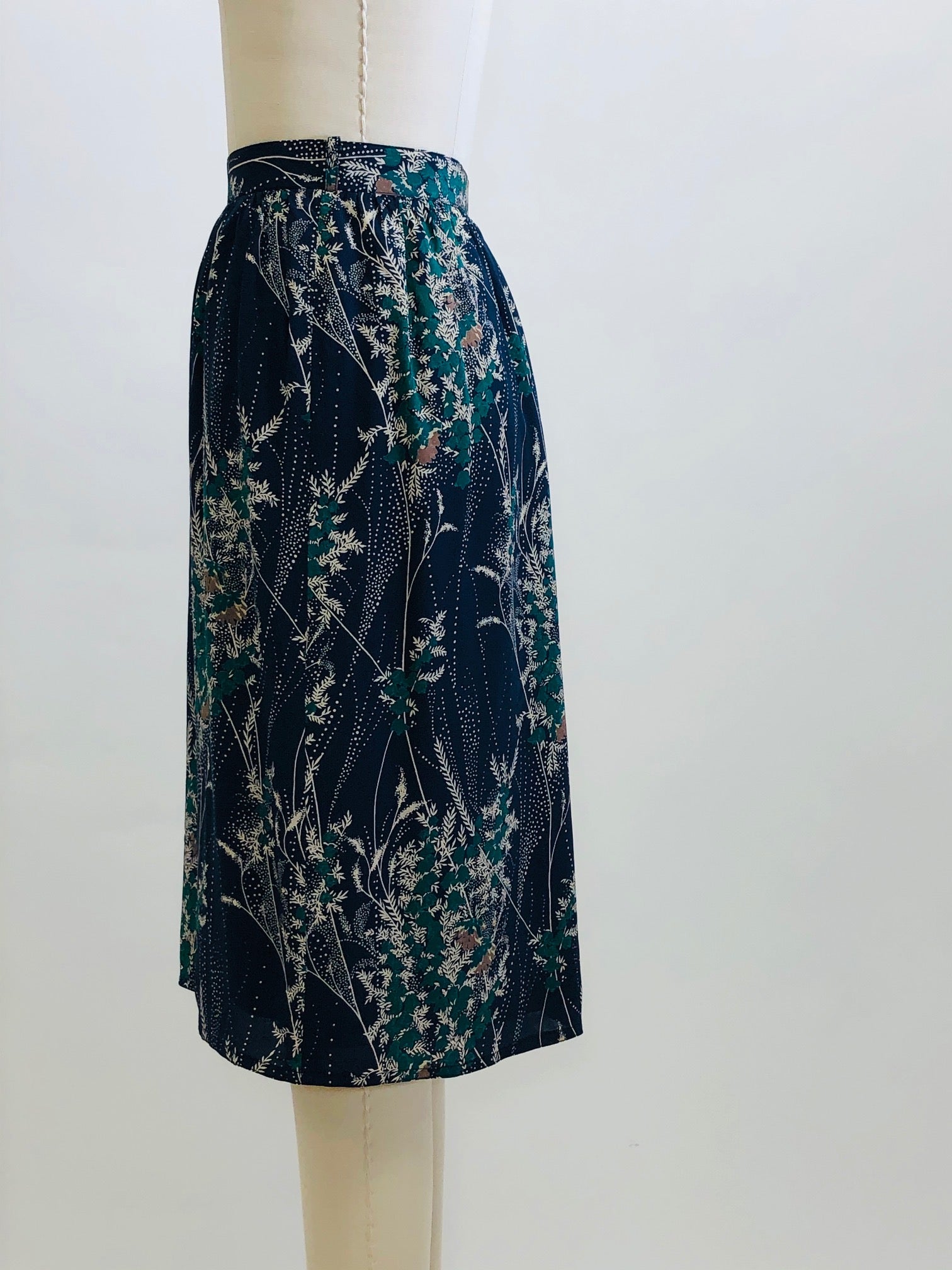 Elegant and timeless vintage knee length, lined skirt with subtle gathering at waistband and back zipper closure. 