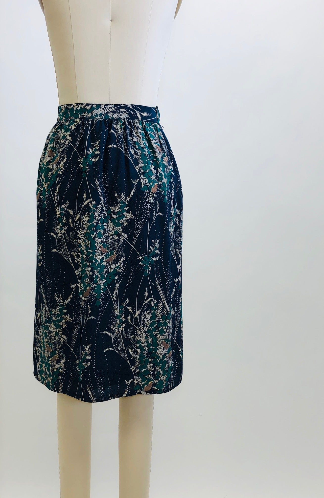 Elegant and timeless vintage knee length, lined skirt with subtle gathering at waistband and back zipper closure. 