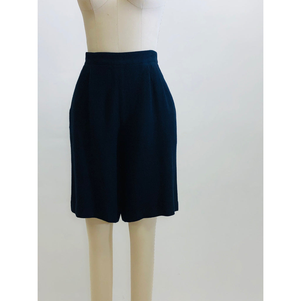 Vintage navy rayon crepe shorts from Hobnobber Canada label, with waist tucks, back zipper and button closure at waistband. This pair of uniquely constructed shorts feature side seam pockets and looks beautiful with flats or heels.