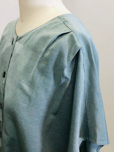 Vintage loose-fitting box shape top with button-down front, short kimono sleeve with interesting shoulder pleat detail. Sage green fabric with slight sheen. Worn like a one-size fits all style; great for tucking into linen trousers or shorts. 